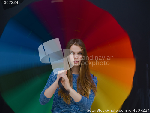 Image of handsome woman with a colorful umbrella