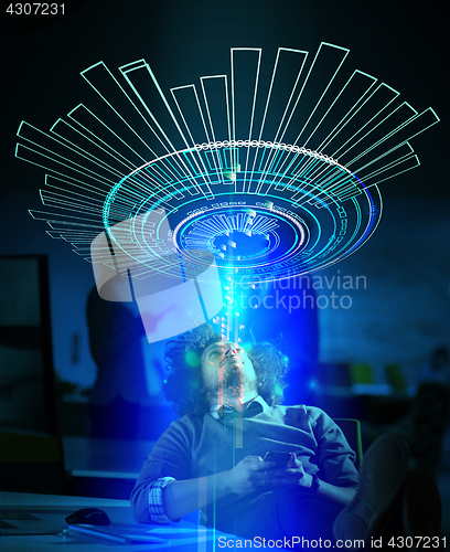 Image of businessman sitting with legs on desk at office