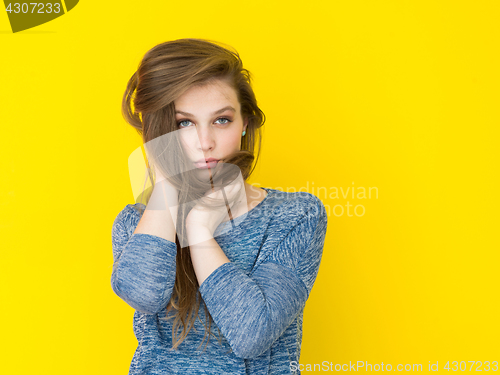 Image of pretty woman playing with her long silky hair