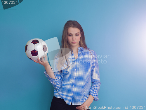 Image of young woman playing with a soccer ball