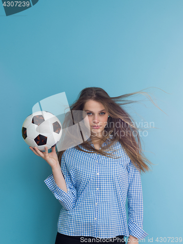Image of young woman playing with a soccer ball