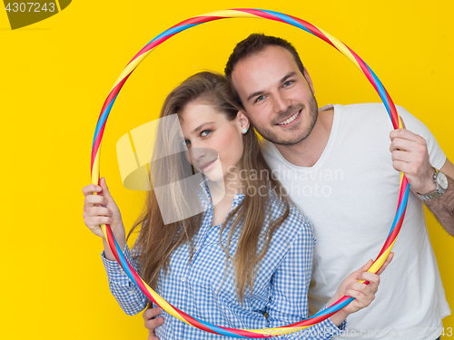 Image of portrait of young couple with hula hoop