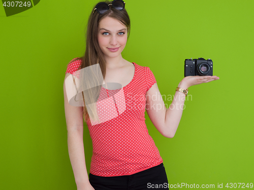 Image of smilling girl taking photo on a retro camera