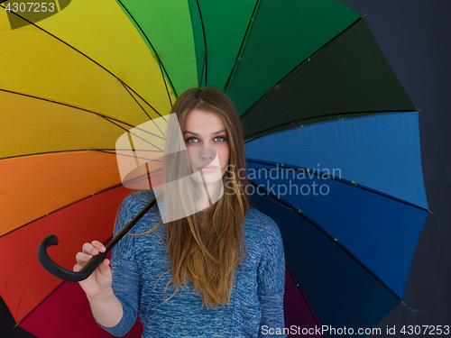 Image of handsome woman with a colorful umbrella