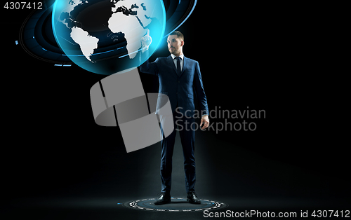 Image of businessman in suit touching earth globe hologram