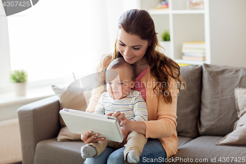 Image of happy mother with baby and tablet pc at home