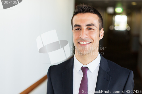Image of businessman in suit at hotel corridor 
