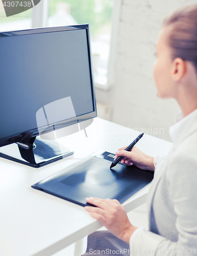 Image of businesswoman with drawing tablet in office