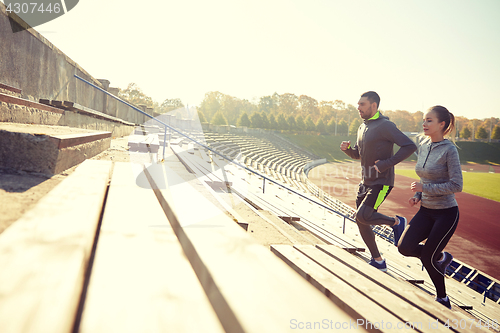 Image of couple running upstairs on stadium