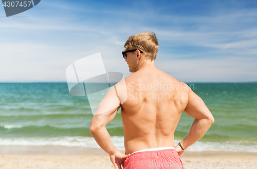 Image of young man on summer beach