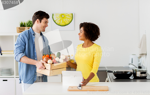 Image of happy couple with healthy food at home kitchen