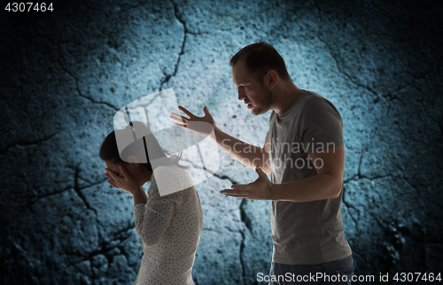 Image of angry man abusing woman