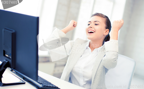 Image of businesswoman with computer in office