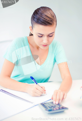 Image of student girl with notebook and calculator