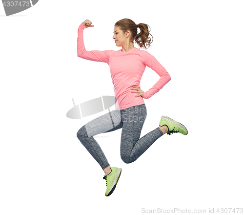 Image of happy smiling sporty young woman jumping in air