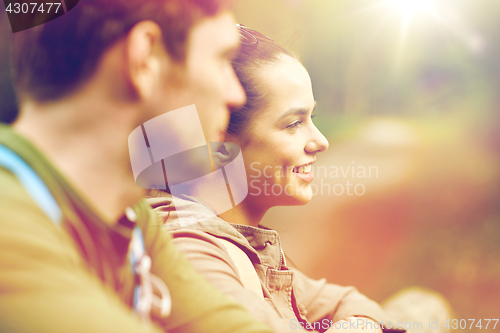 Image of smiling couple with backpacks in nature