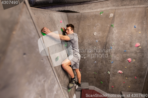 Image of young man exercising at indoor climbing gym