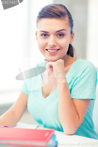 Image of happy smiling student girl with books