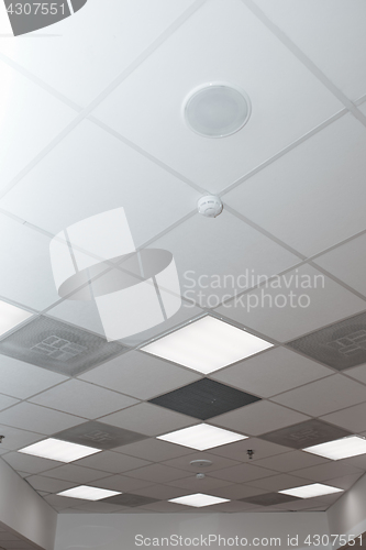 Image of Office room ceiling with smoke detector and alarm