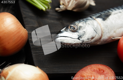 Image of Mackerel and vegetables on a wooden table