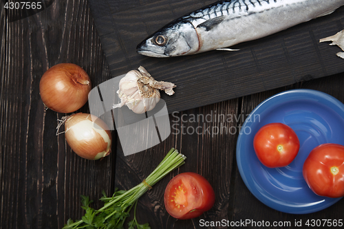 Image of Mackerel and vegetables on a wooden table