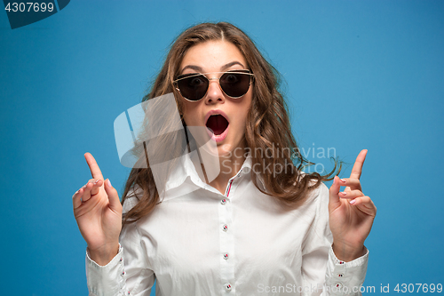 Image of Portrait of young woman with shocked facial expression