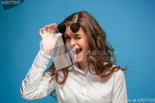 Image of Portrait of young woman with shocked facial expression