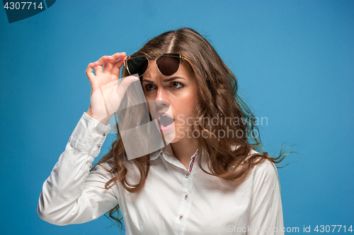 Image of Portrait of young woman with shocked facial expression