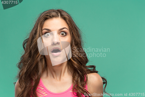 Image of Portrait of young woman with shocked facial expression