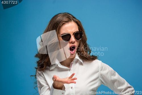 Image of Portrait of young woman with shocked facial expression