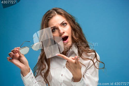 Image of Portrait of young woman with shocked facial expression