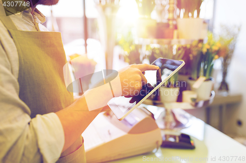 Image of close up of man with tablet pc at flower shop