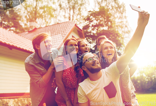 Image of friends taking selfie at party in summer garden