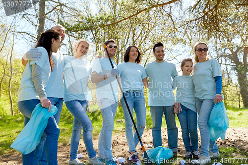 Image of volunteers with garbage bags cleaning park area