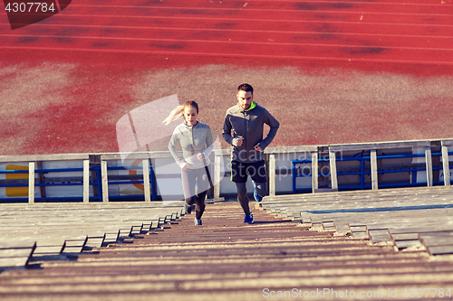 Image of couple running upstairs on stadium