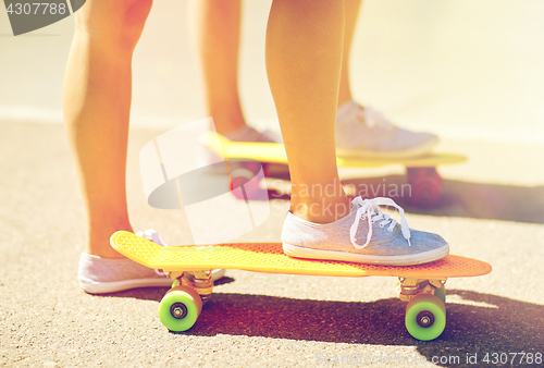 Image of close up of female feet riding short skateboard