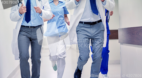 Image of close up of medics or doctors running at hospital