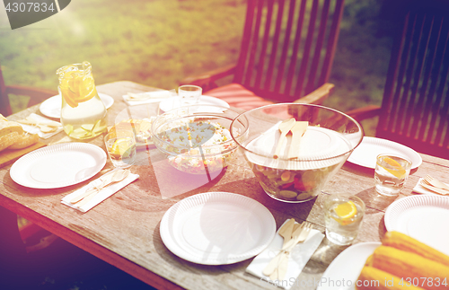 Image of table with food for dinner at summer garden party