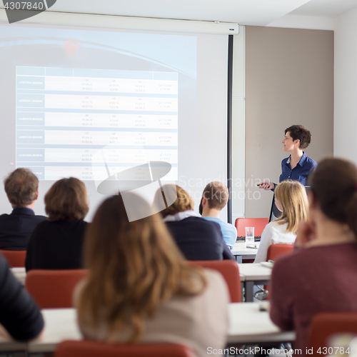 Image of Woman giving presentation in lecture hall at university.