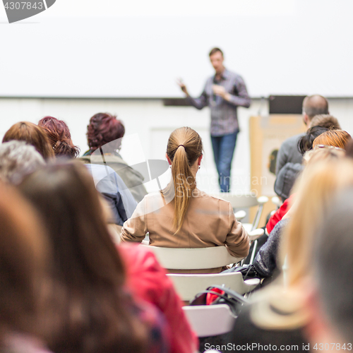 Image of Public speaker giving talk at Business Event.