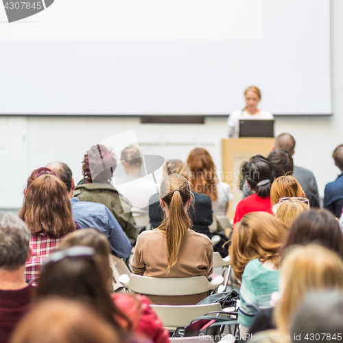 Image of Woman giving presentation in lecture hall at university.