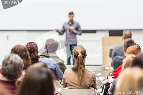 Image of Public speaker giving talk at Business Event.