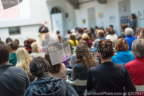 Image of Public speaker giving talk at Business Event.