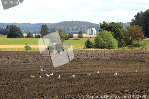 Image of Landscape of Tractor Working on Field