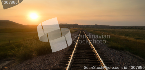 Image of Railroad Tracks Reflect Sunrise Rural American Transportation La