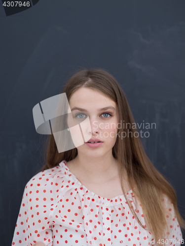 Image of woman blowing confetti in the air isolated over gray