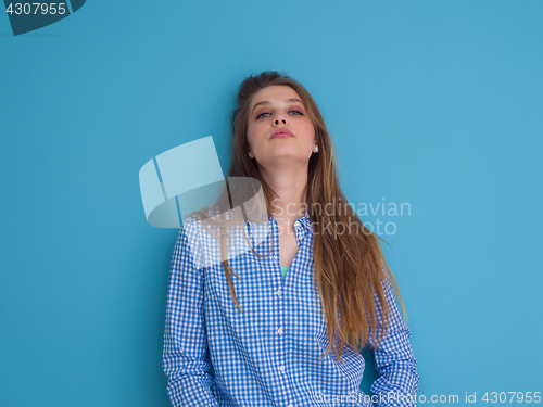 Image of young woman playing with her long silky hair