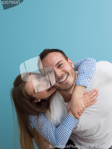 Image of young man piggybacking his girlfriend