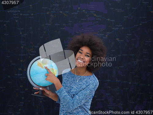 Image of black woman holding Globe of the world