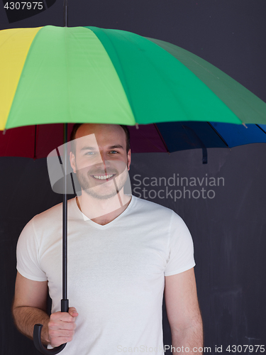 Image of handsome man with a colorful umbrella